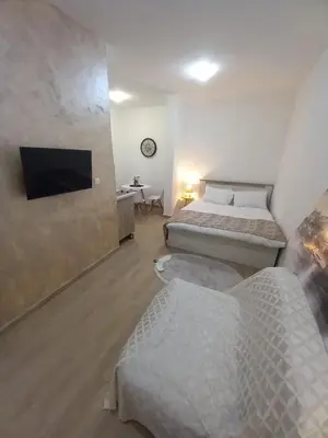a bedroom with two beds and a flat screen tv at CASA APARTMENTS, one-bedroom apartment in Budva