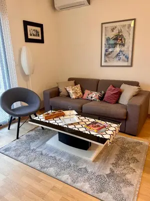 a living room with a couch and a coffee table at Lovely Modern LUX flat near to the center in Podgorica