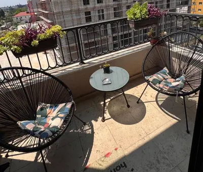 two chairs and a table on a balcony at Lovely Modern LUX flat near to the center in Podgorica