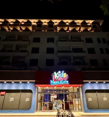 a restaurant with a neon sign on the side of a building at Lovely Modern LUX flat near to the center in Podgorica