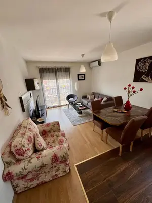 a living room with a couch and a table at Lovely Modern LUX flat near to the center in Podgorica