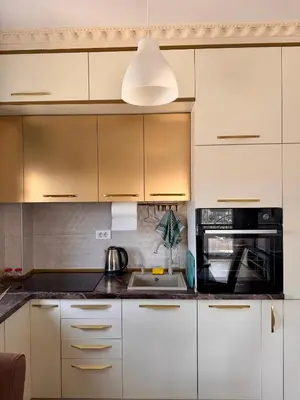 a kitchen with white cabinets and a sink at Lovely Modern LUX flat near to the center in Podgorica