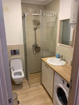 a bathroom with a shower and a toilet and a sink at Cozy apartment in The Old Bakery Residences in Budva