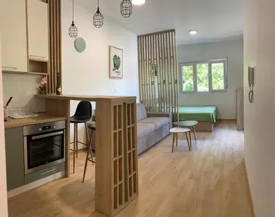 a kitchen and living room with a couch and a table at Cozy apartment in The Old Bakery Residences in Budva