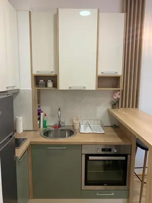 a kitchen with a sink and a counter top at Cozy apartment in The Old Bakery Residences in Budva