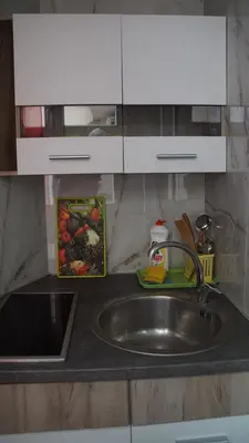 a kitchen counter with a sink and a bowl of food at Villa Stanivukovic in Budva