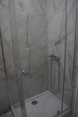 a bathroom with a shower with a glass door at Villa Stanivukovic in Budva