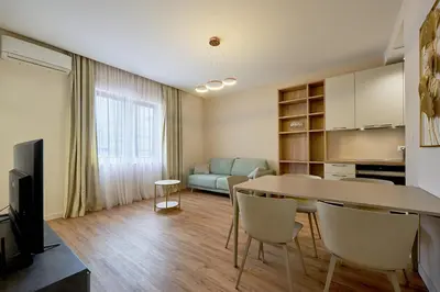 a kitchen and living room with a table and chairs at BigMontenegro Belveder in Becici