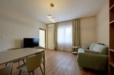 a living room with a table and a couch at BigMontenegro Belveder in Becici
