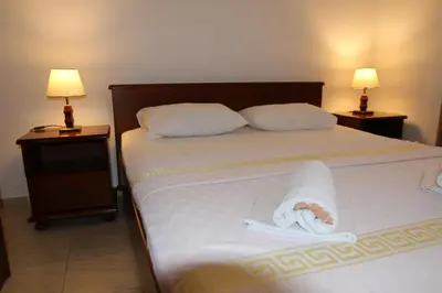 a bedroom with a bed with a towel on it at Apartments Muhar in Sveti Stefan