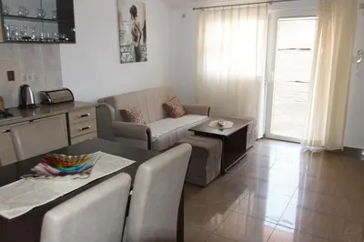 a living room with a couch and a table at Apartments Muhar in Sveti Stefan