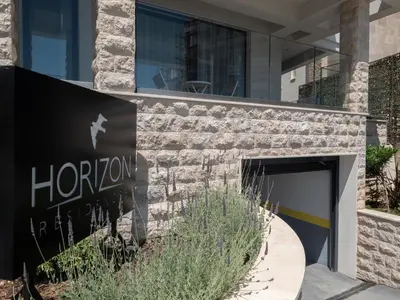 a sign for a hotel in front of a building at Horizon Residences Andjela in Budva