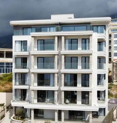 a large white building with many windows at Horizon Residences Andjela in Budva