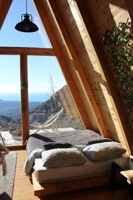 a bed in a room with a large window at Horizon Lodge Medurec in Ulcinj