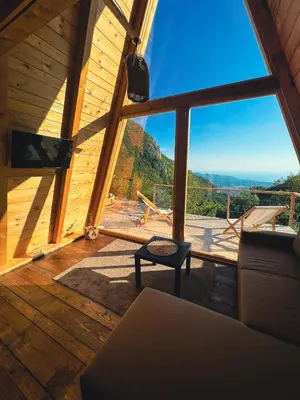 a living room with a large window with a view at Horizon Lodge Medurec in Ulcinj