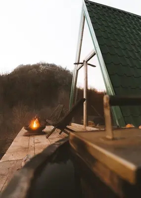 a fire sitting on a dock next to a cabin at Horizon Lodge Medurec in Ulcinj