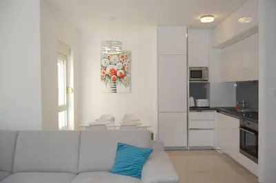 a living room with a couch and a kitchen at Status-M Apartments 85 in Becici