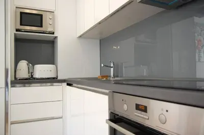 a kitchen with a counter with a sink and a microwave at Status-M Apartments 85 in Becici