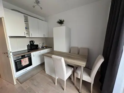 a small kitchen with a wooden table and chairs at Engora 2 in Petrovac na Moru