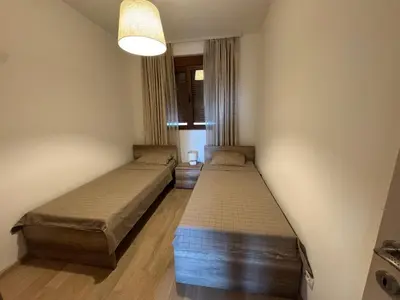 two beds in a small room with a lamp at Engora 2 in Petrovac na Moru