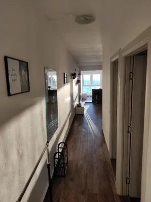a living room with a hallway with a hard wood floor at Apartment A4 in Ulcinj