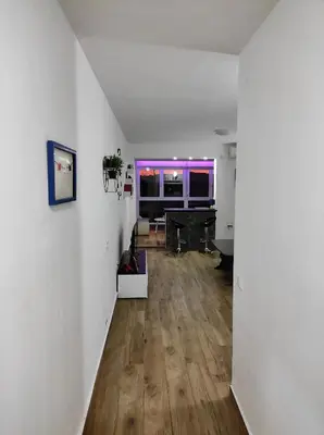 a living room with a piano and a white wall at Apartment A4 in Ulcinj