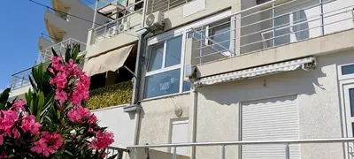 an open window of a building with pink flowers at Apartment A4 in Ulcinj