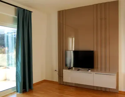 a living room with a tv and a window at Status-M apartments 98 in Becici