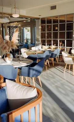 a dining room with tables and chairs in a restaurant at Status-M apartments 98 in Becici