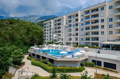an external view of a hotel with a swimming pool at Status-M apartments 98 in Becici