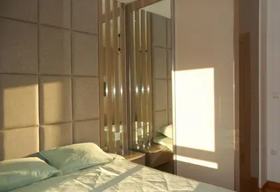 a bedroom with a bed and a large mirror at Status-M apartments 98 in Becici