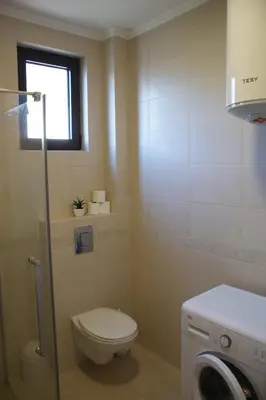 a small bathroom with a toilet and a window at Engora 5 in Petrovac na Moru