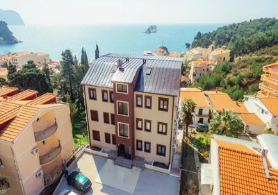 an aerial view of a city with buildings and the ocean at Engora 5 in Petrovac na Moru