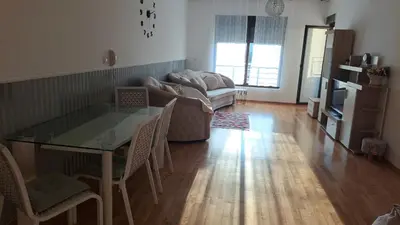 a living room with a glass table and a couch at Marina Apartment in Becici