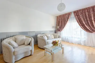 a living room with two chairs and a table at Marina Apartment in Becici