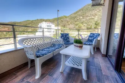 a balcony with chairs and a table with a view at Marina Apartment in Becici