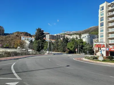 an empty street in a city with buildings at Marina Apartment in Becici