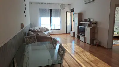 a living room with a couch and a glass table at Marina Apartment in Becici
