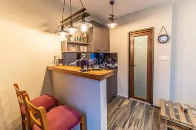a kitchen with a bar and a dining room at Apartman_PidžuN in Cetinje