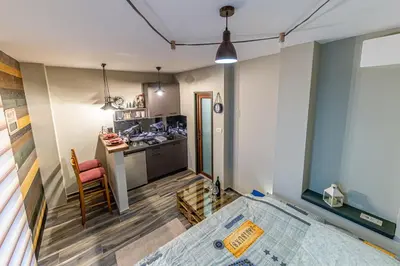 a small kitchen with a table in a room at Apartman_PidžuN in Cetinje