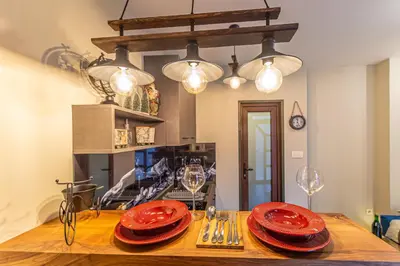 a table with red plates and wine glasses on it at Apartman_PidžuN in Cetinje