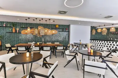 a restaurant with tables and chairs in a room at Hotel TQ Plaza in Budva