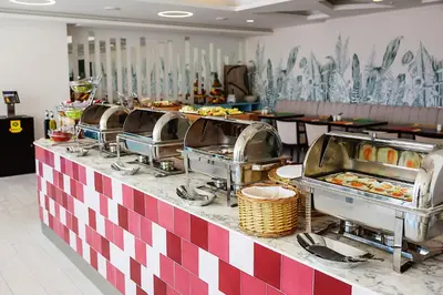 a buffet line with many trays of food at Hotel TQ Plaza in Budva
