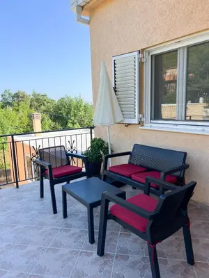 a group of chairs and a table on a patio at Villa Pari Apartment in Kotor