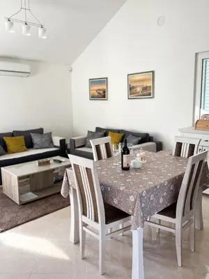 a living room with a table and a couch at Villa Pari Apartment in Kotor