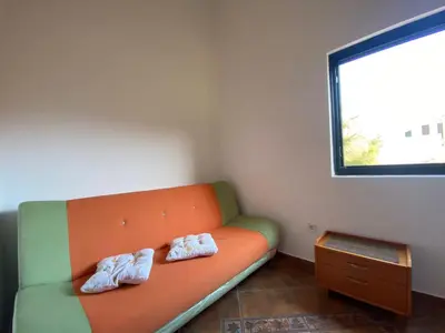 two pairs of mens shoes sitting on a couch at Villa Lutovac Budva in Budva