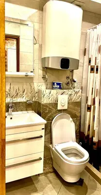 a bathroom with a white toilet and a sink at Apartaments Charlie Chaplin in Kotor