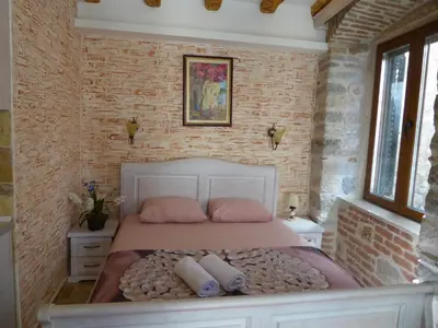 a bedroom with a bed with two pillows on it at Apartaments Charlie Chaplin in Kotor