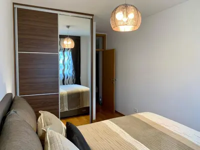 a room with a mirror and a couch and a bedroom at Panorama Bar 2 bedroom in Bar