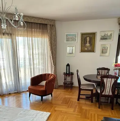 a living room with a dining room table and chairs at Panorama Bar 2 bedroom in Bar